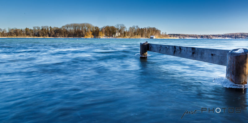 Winter am Wörthsee (Blick auf die Mausinsel, im Vordergrund Reste eines Stegs; Pfosten mit Eis)