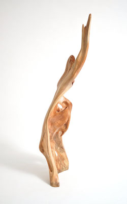 Abstract willow wood sculpture S0198 by Jörg Pietschmann, featuring a tall, flame-like vertical shape with smooth curves, natural openings, and a polished warm honey-brown texture.