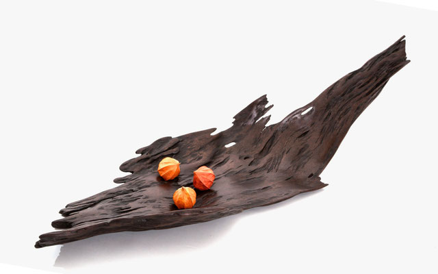 Harmonious designer bowl V1042 in exotic tropical wood – an evocative hollowed sculpture by Jörg Pietschmann, hand-finished to balance raw organic textures with sophisticated geometric mass, infusing modern spaces with the primeval elegance of the woods.