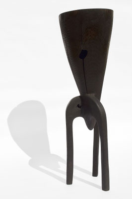 Abstract three-legged dark oak wood sculpture V1457 by Jörg Pietschmann, featuring a conical top with a natural hole and crack, studio shot on a white background.