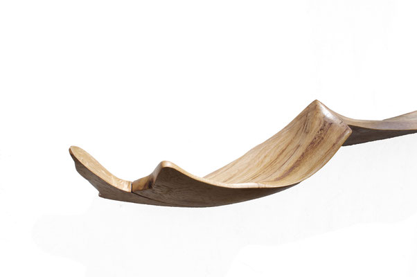 Harmonious wall console W2380 in robust oak – an evocative functional sculpture by Jörg Pietschmann, hand-finished to balance raw organic textures with clear geometric presence, infusing modern spaces with the primeval elegance of the woods.