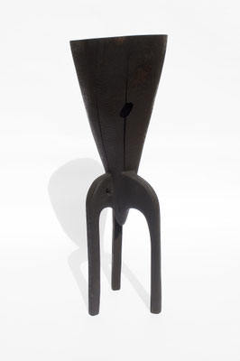 Abstract three-legged dark oak wood sculpture V1457 by Jörg Pietschmann, featuring a conical top with a natural hole and crack, studio shot on a white background.