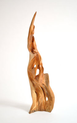 Abstract willow wood sculpture S0198 by Jörg Pietschmann, featuring a tall, flame-like vertical shape with smooth curves, natural openings, and a polished warm honey-brown texture.