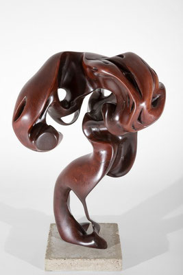 Abstract redwood sculpture S1012 by Jörg Pietschmann, featuring a dynamic biomorphic shape with smooth, dark reddish-brown polished wood curves, loops, and organic hollow cavities, mounted on a square concrete base against a white studio background.