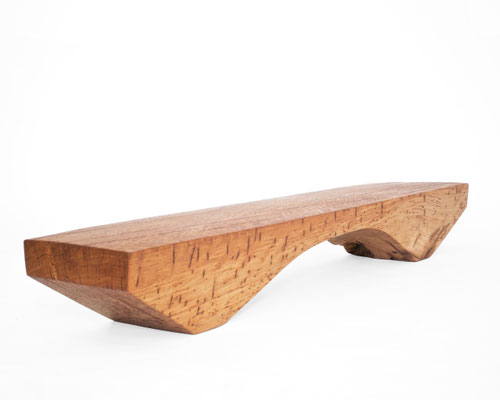 Archaic designer bench B2461 in organically perforated oak – a monumental functional sculpture by Jörg Pietschmann, celebrating the dense growth and rugged fissures of ancient timber to bring the eternal rhythm of the wildwood into premium minimalist spac