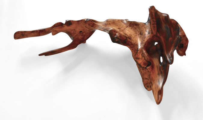 Abstract mastix bush root sculpture S1090 by Jörg Pietschmann, featuring polished reddish-brown wood with intense grain patterns, fluid organic shapes, and branch-like prongs on a solid white background.
