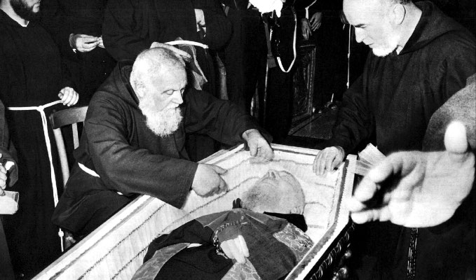 Padre Raffaele D'Addario da Sant'Elia a Pianisi, suo amico e confessore per molti anni, adagia un velo sul volto del Confratello defunto. Accanto, padre Carmelo da Sessano