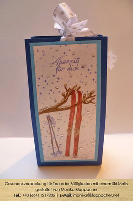 Geschenkverpackung für Tee und Schokoriegel mit einem Ski-Motiv