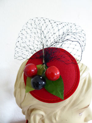 red velvet base with black netting and vintage cherries. €69