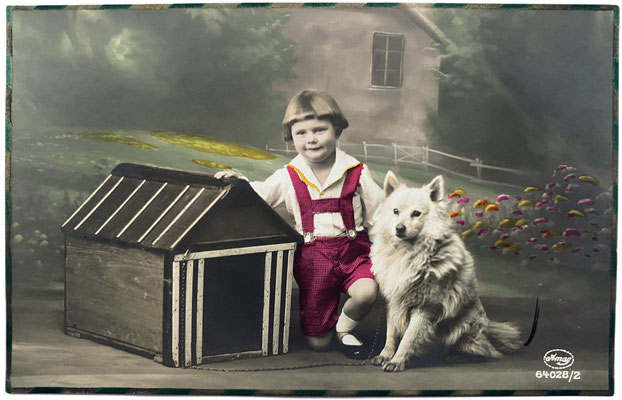 Little boy with his white German Spitz