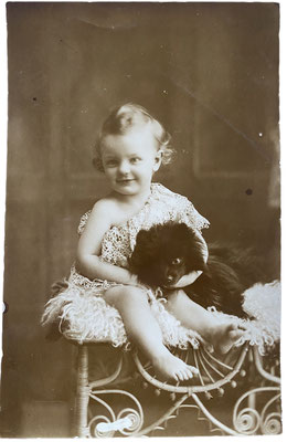 Toddler with black Toy Spitz