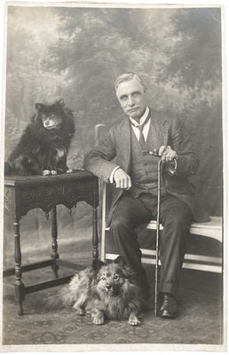 A Gentleman with his two Pomeranians