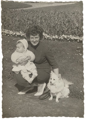 Proud lady with grandchild and German Spitz