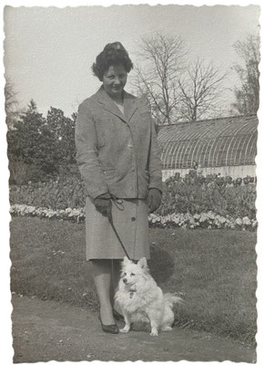 Nice woman with German Spitz on the leash