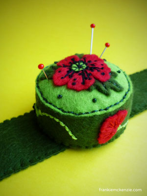 Green wrist pincushion with red poppies