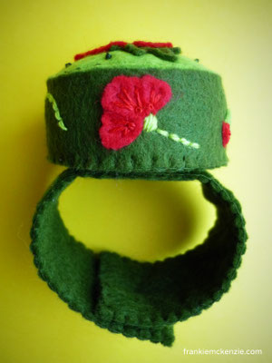 Green wrist pincushion with red poppies