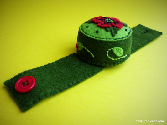 Green wrist pincushion with red poppies