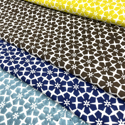 Assorted block print patterns in our Delhi factory shop. Our fabrics are more than textiles—they are a tribute to the artisans who bring them to life, preserving heritage.