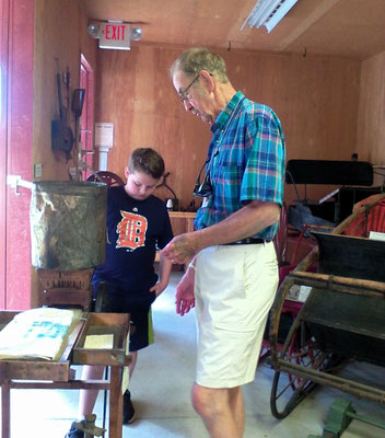 Robert, museum volunteer and voice of the Witness Tree, discusses artifacts with his grand nephew   [photo by Arlene]