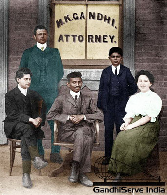 3 - Mahatma Gandhi sitting with his private secretary, Ms. Sonia Schlesin (right) and Henry S. Polak (left) in front of his office at Rissik & Anderson Streets, Johannesburg, 1905. Standing behind Gandhi: Coopoo Moonlight Moodley (left).