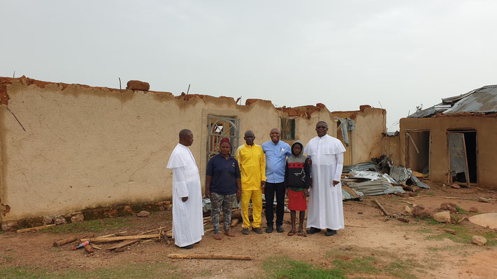 Monsignor Obiora Ike (center) with survivors of a recent Fulani militia attack.