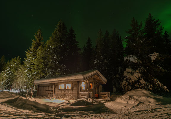 Log cabin under the northern lights