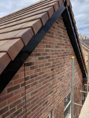 Decorative brick panels prior to application of Tudor laths