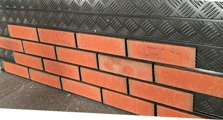 Red Brick Slips mounted onto a Brickk Slip Tracking panel. Partially installed.