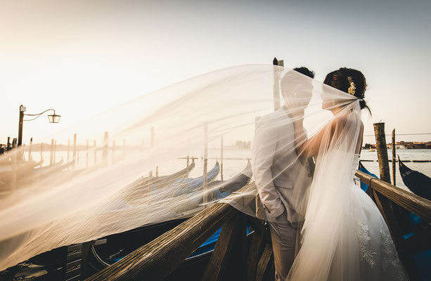 Photographer capturing couple on quiet canal during blue hour