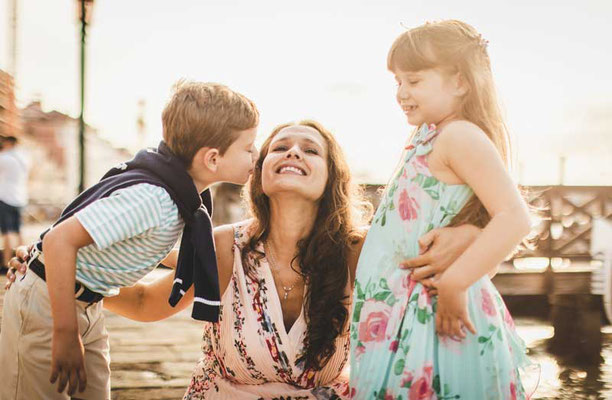 A family portrait in Venice reflecting genuine happiness and connection, taken by a local photographer capturing their unique bond amidst the city's beauty.