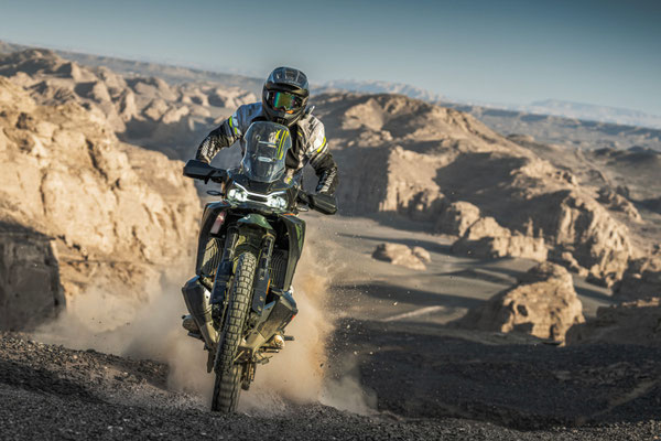 CFMOTO 1000MT-X - Tactical Green - fahrend durch felsige Hügellandschaft