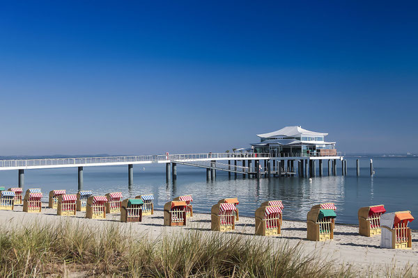 Beach baskets at Timmendorfer Strand with Seeschloesschenbruecke and Japanese teahouse, Luebeck Bay, Baltic Sea, Schleswig-Holstein, Germany