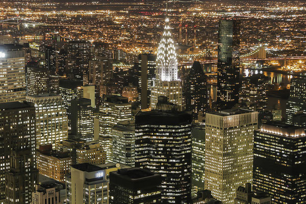 Night shot of the Empire State building, New York skyline at night, in the background the Brooklyn bridge, New York City, USA