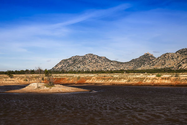 Mountainous coastal landscape near Ca Na, in the foreground an artificial lake for salt production, Ninh Thuan, Vietnam, Asia