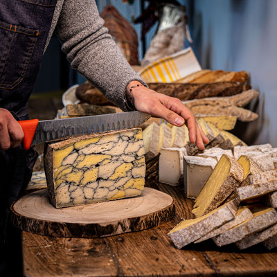 Fromage marbré de la fromagerie de Blanzay, des tranches de fromages et du pain forme un décor de second plan 