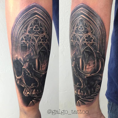 Tatuaje en realismo de una calavera con una ventana gótica.