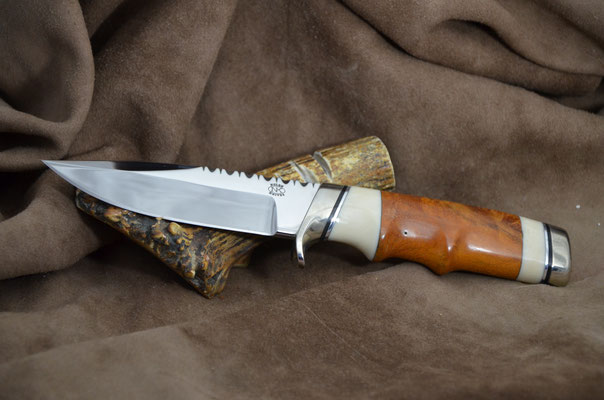 #192 Narrow tang double edge clip point.  Blade length 4 1/2" Overall 9" Made with 440C.  Maple burl with white corrion with nickel silver guard and buttcap.  Maker RD Nolen $375