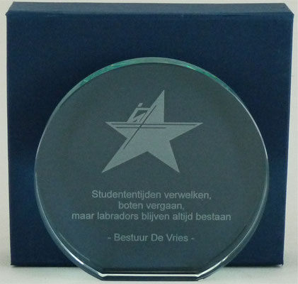 Glazen schijf met gravering van logo en tekst.