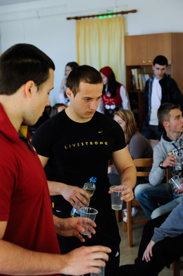 Bulgarians giving others to taste Bulgarian traditional drink