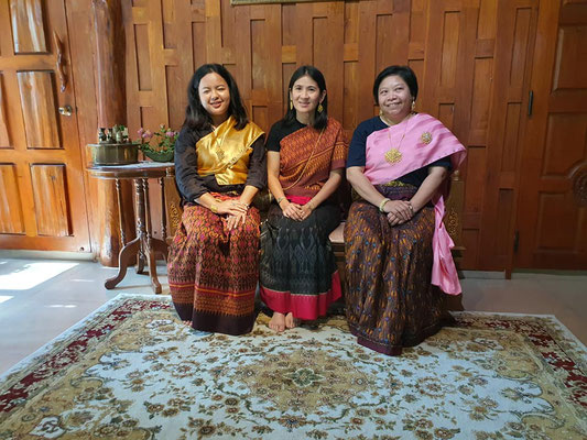 Thai women wearing traditional silk dresses 