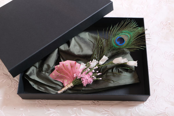 Regency-style silk bonnet in green with peacock feather decoration, laying in black box
