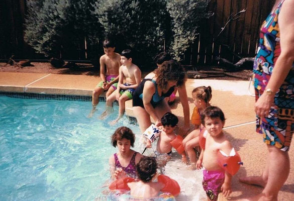 Kevin still in the water, back to the camera. Little Joe is on the bottom right in pink shorts, looking at the camera.