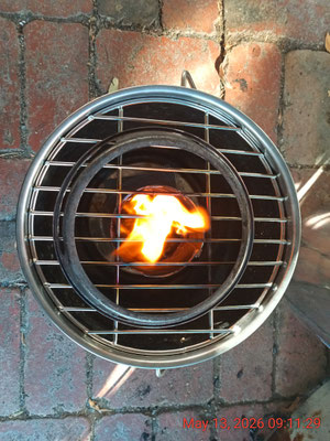 Navigator 'Hormuz' V1 TLUD - 4" 304 chimney flue burner in a 12L ss bucket with round grill and wok ring stovetop. Integrated with the 'Simple Survival System'
