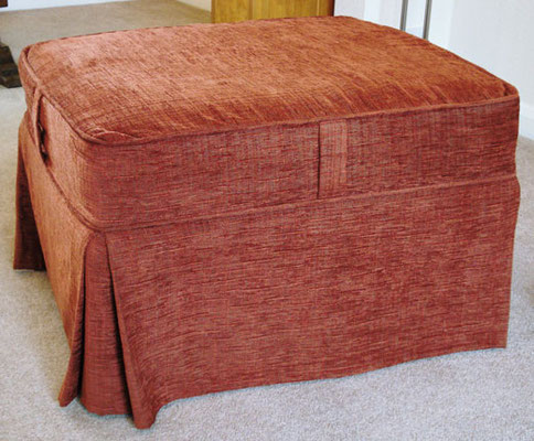 A fitted pull on cover for a footstool pouffe