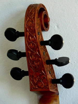relief carving on pegbox and scroll with extra animals added - violworks