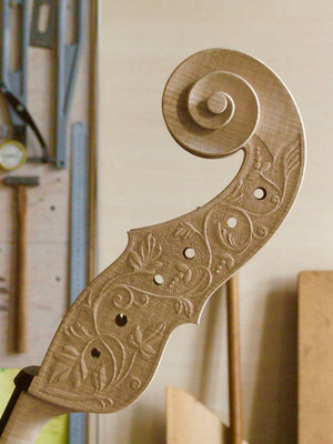 relief carving on the pegbox of a violone - violworks