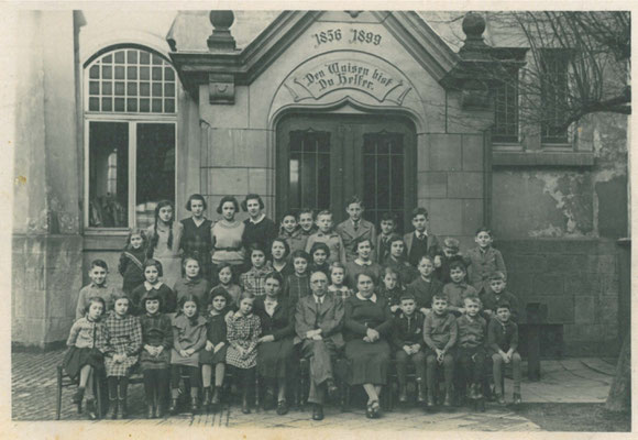 in front of the entarnce of the orphanage