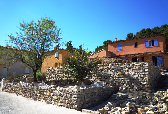 Vue 3/4 chantier avec restanque basse en dressage de parement et restanque haute achevée