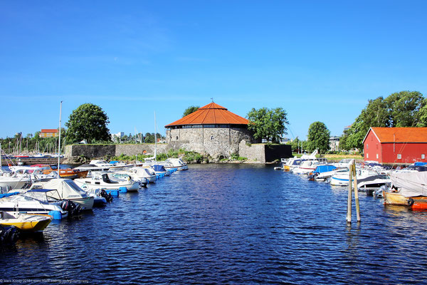 A yacht harbour of Kristiansand with fortress Christiansholm in the background