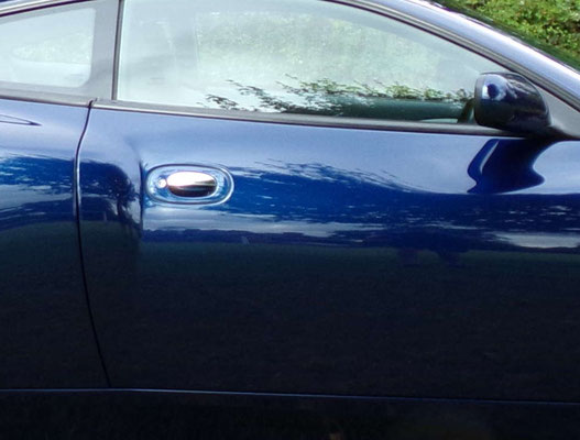 Close up of full body work by Precision Paint on a blue Aston Martin Vanquish S